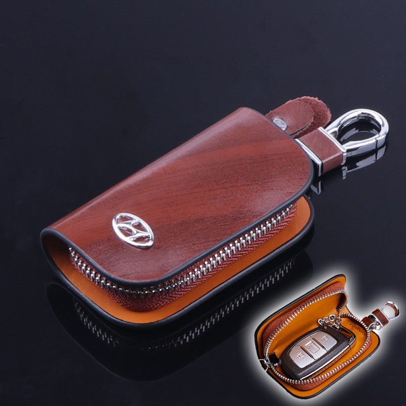 https://homeessentialstore.com/cdn/shop/products/car-logo-leather-wood-texture-car-key-case-857113_1024x.jpg?v=1662915957